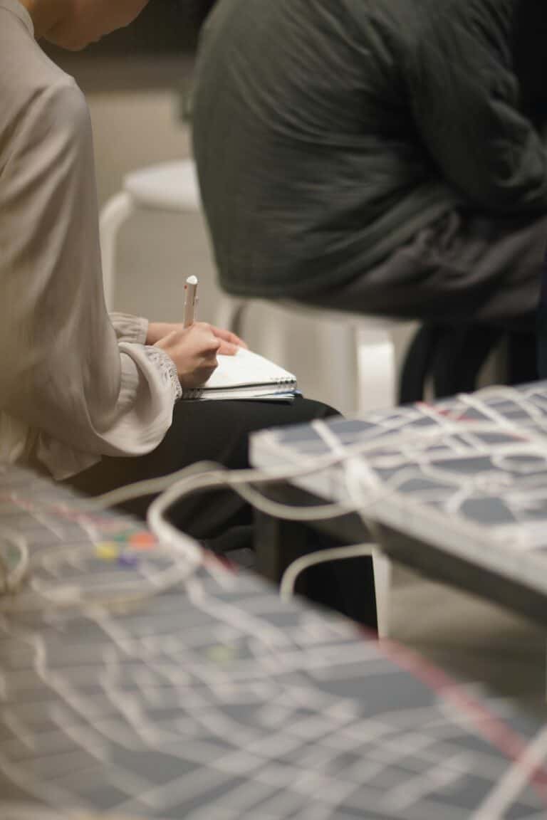 A person taking notes during a meeting