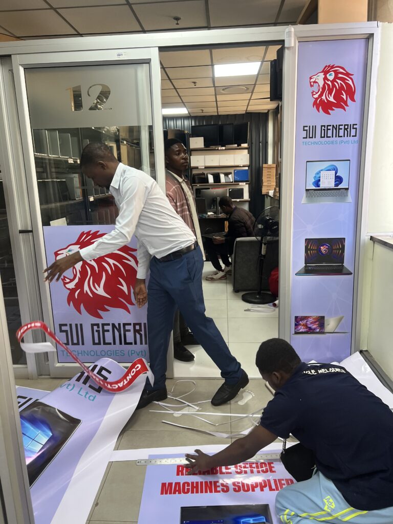 JomeTech team installing branded display graphics